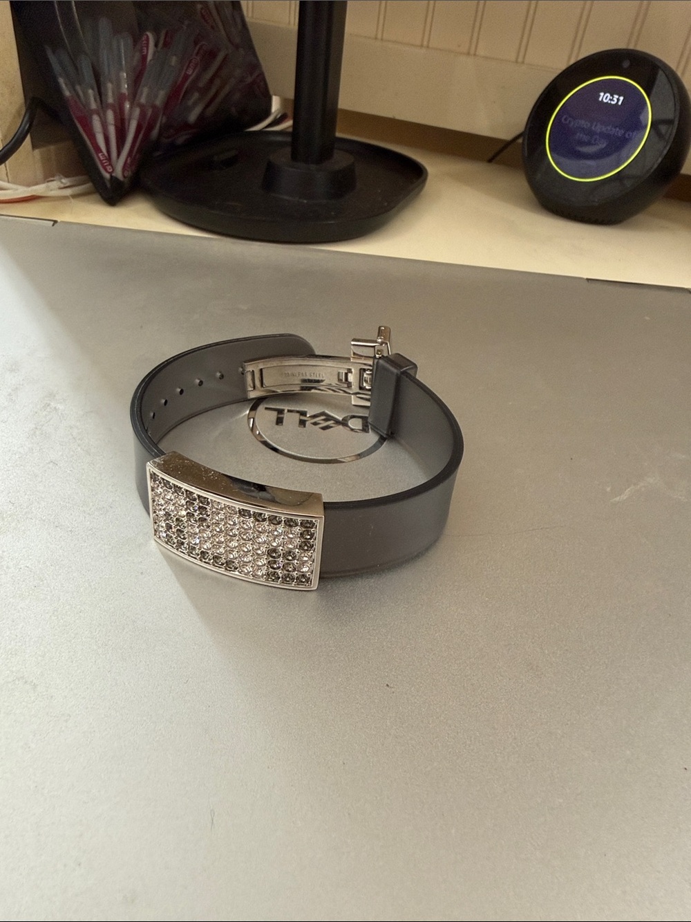 Swarovski embellished with crystals .  Strap is a gray watch like strap